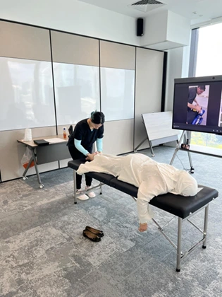 Our chiropractor is performing a soft tissue technique on a woman's upper back to relieve back pain