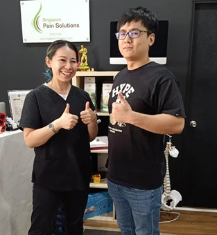 Our chiropractor with a happy customer after the back pain relief session