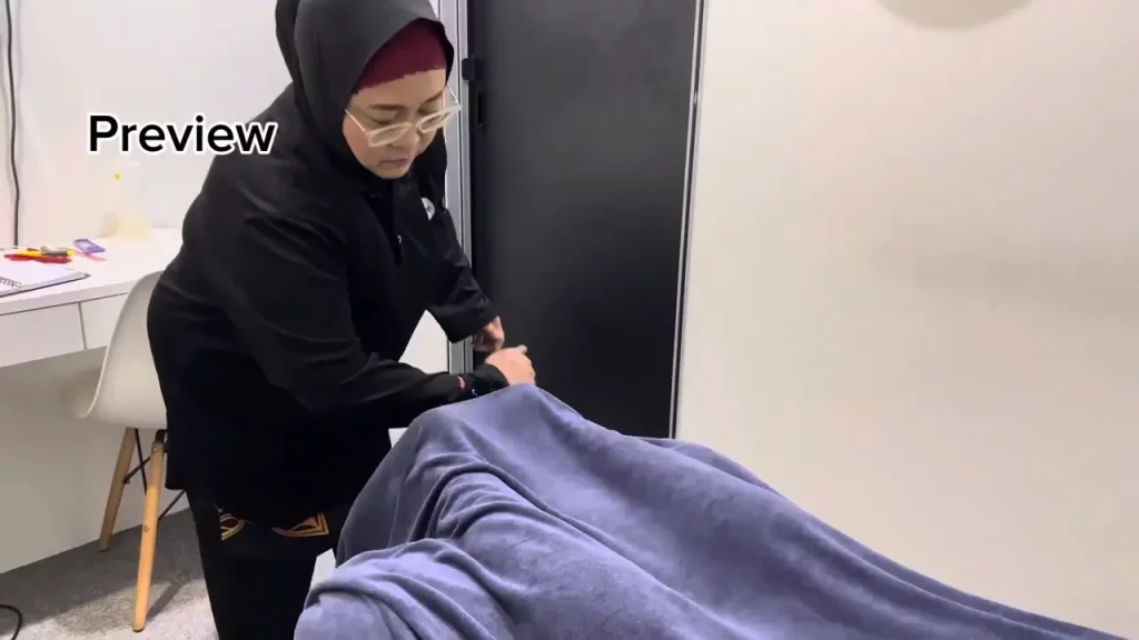 A sports massage therapist treating back and shoulder stiffness on a patient to improve flexibility and reduce muscle soreness.