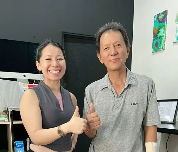 An old man with our chiropractor Dr Jenny