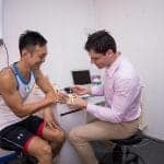 Dr Jeff attending to his athlete patient