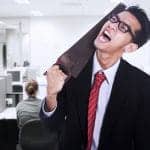 a frustrated man putting a saw on his neck