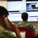 saf soldiers working with a computer and a phone