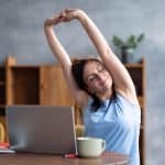 woman doing some stretching exercises in home office