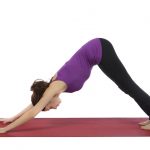 Young woman in Downward Facing Dog Pose