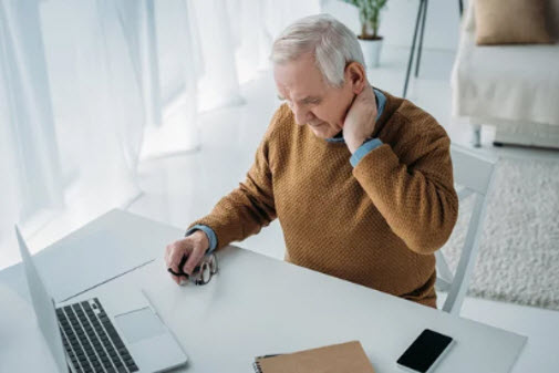 Elderly man suffering from neck pain, exploring chiropractic treatment with dry needling in Singapore