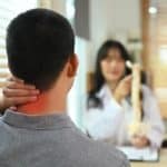 A Chiropractor explaining the neck condition to her patient