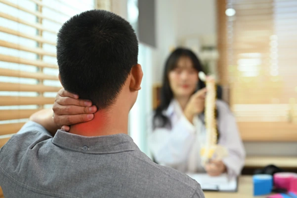 A Chiropractor explaining the neck condition to her patient