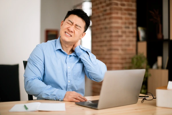 An office worker suffering from a neck pain