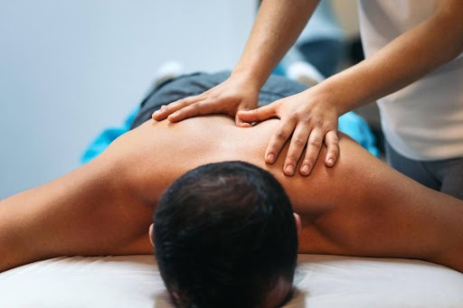 A patient receiving sports massage treatment